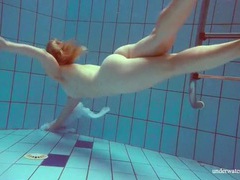 UhEbony presents: Redhead goes for a nude swim in the pool